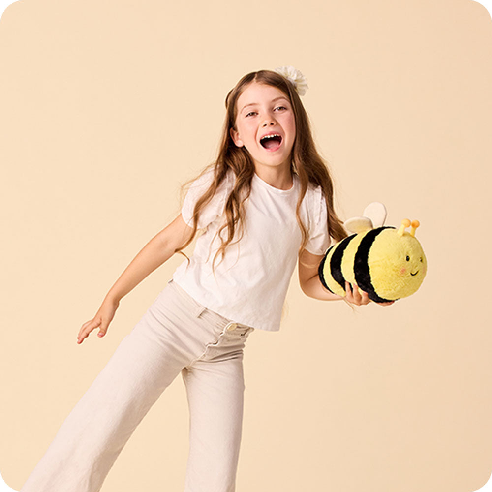 girl holding bee stuffed animal