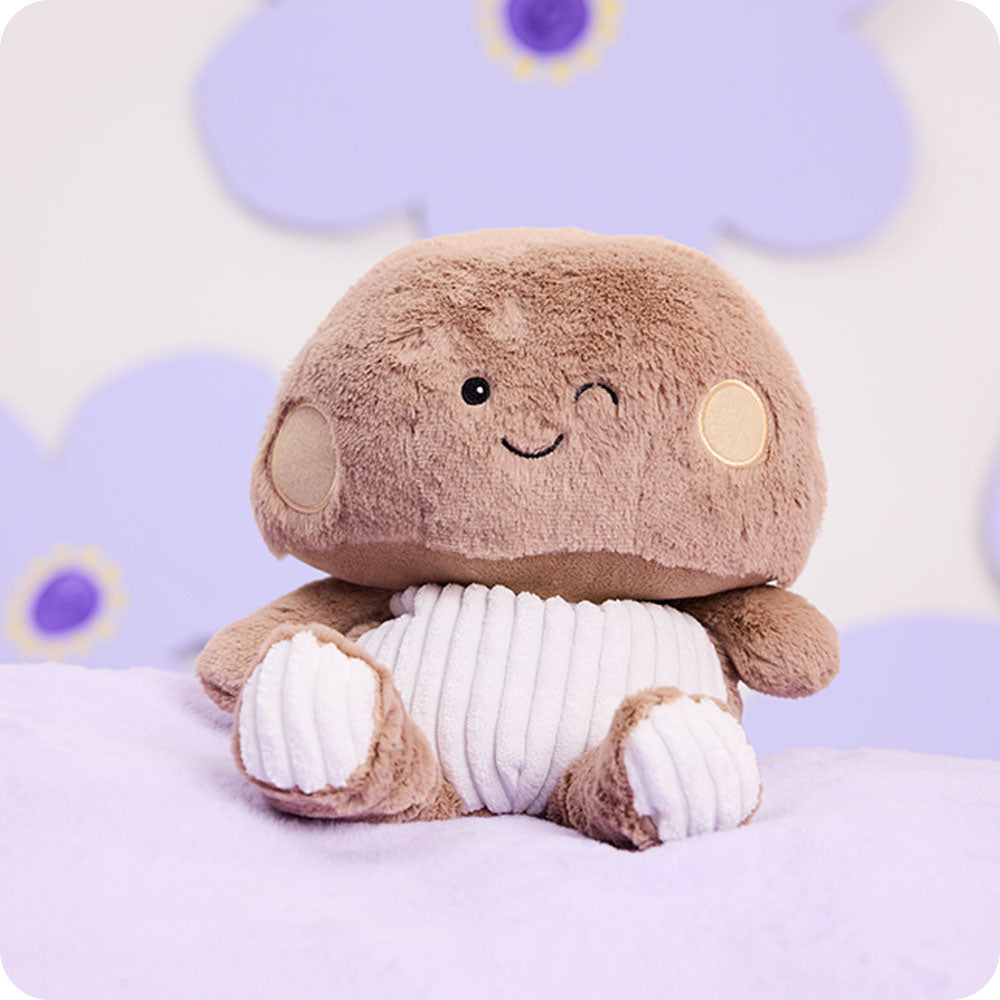 brown mushroom stuffed animal on purple background