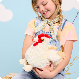 girl holding chicken stuffed animal warmies