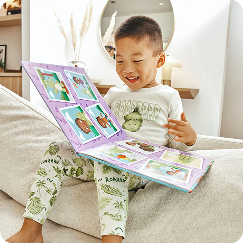 boy laughing and reading warmies Dinosaur Discovers Confidence book