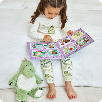 girl reading Dinosaur Discovers Confidence warmies book