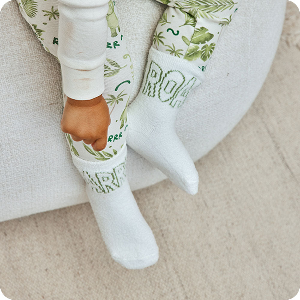 boy wearing dinosaur roar socks