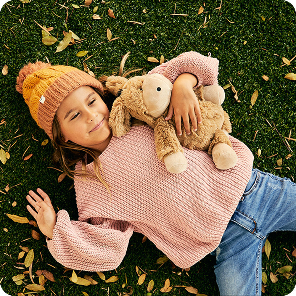 autumn leaves and girl holding donkey stuffed animal
