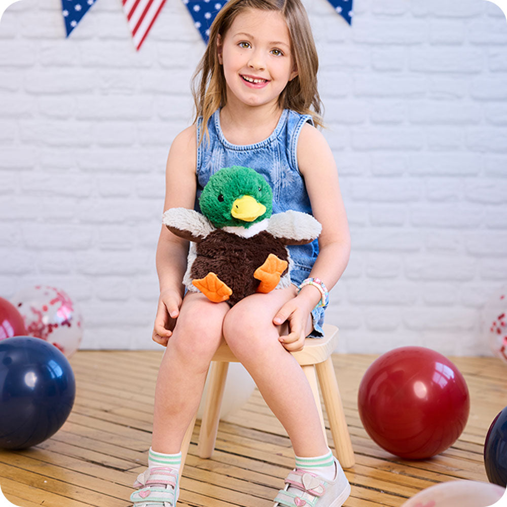 girl with mallard duck stuffed animal on her lap