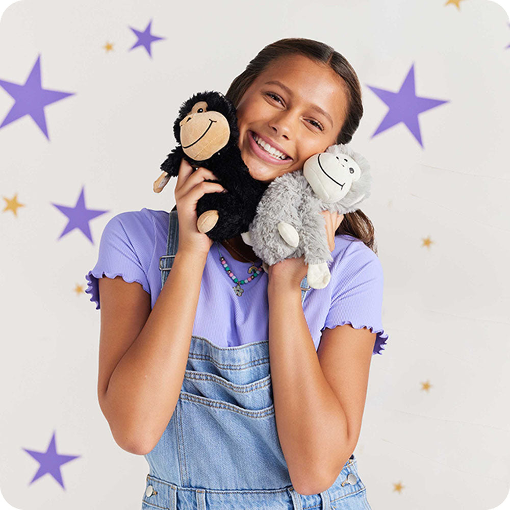 girl cuddling monkey hugs stuffed animals