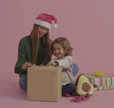 A video of a young girl helping her little brother open up presents and playing with Warmies.