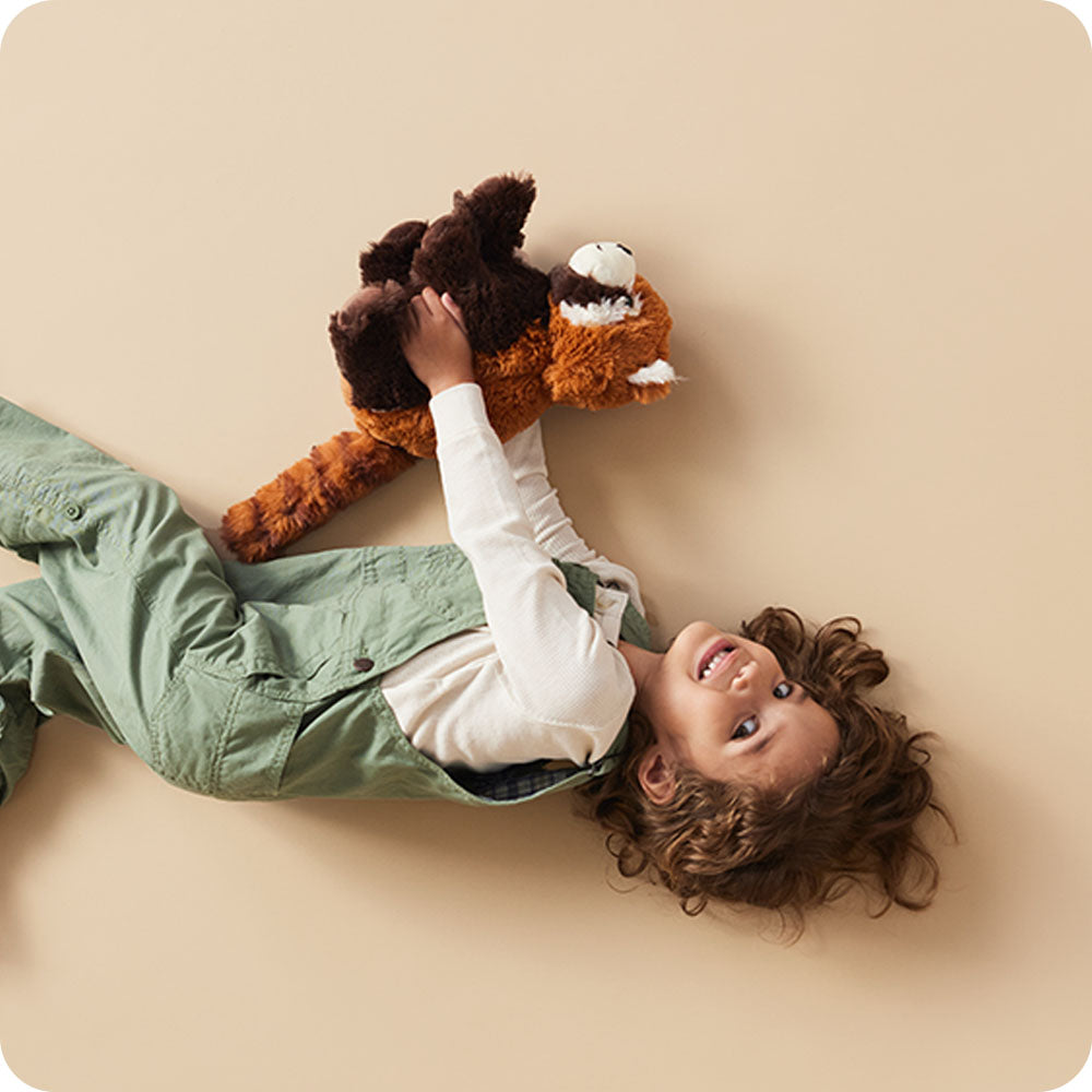 girl holding red panda stuffed animal