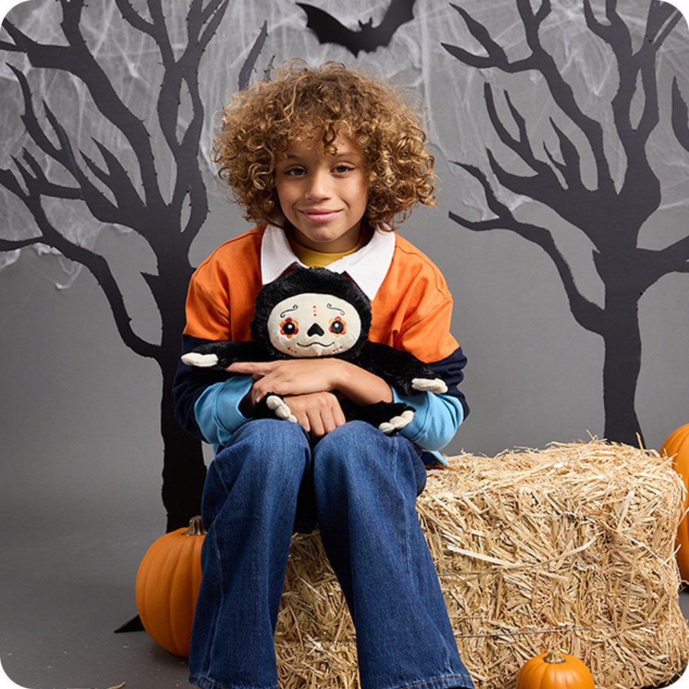 boy hugging day of the dead sloth 