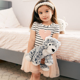 girl holding snow leopard stuffed animals