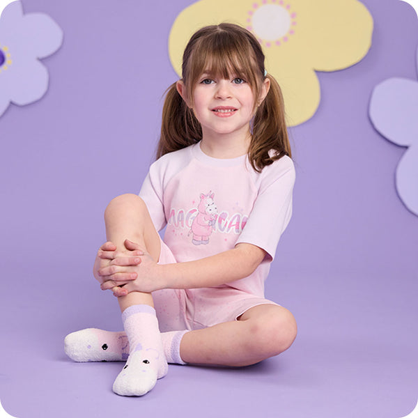 girl wearing warmies unicorn pajamas