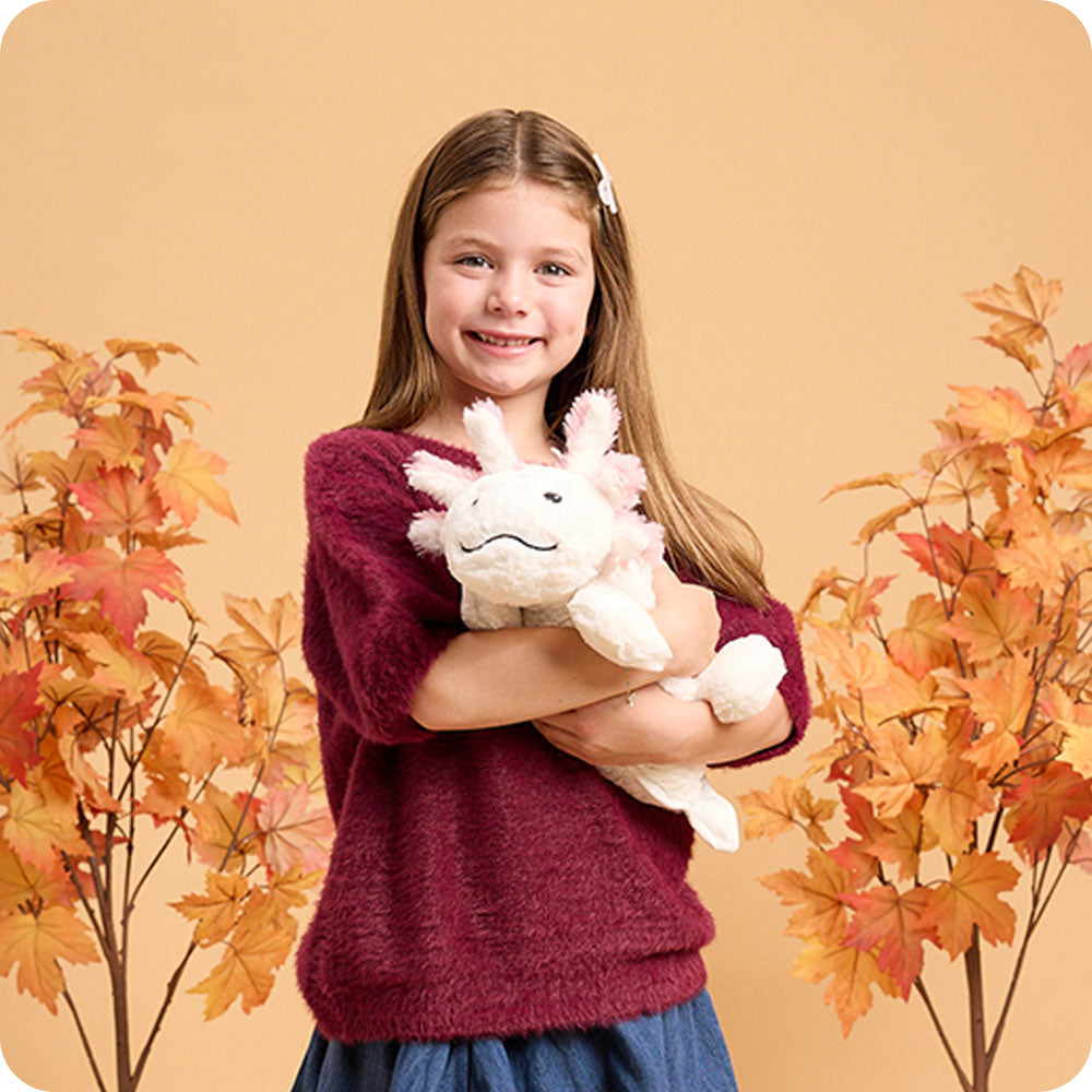 girl holding white axolotl warmies autumn lifestyle