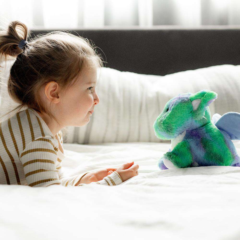 Little girl looking at Cute Weighted Lavender Scented Baby Dragon Stuffed Animal Heating Pad Warmies
