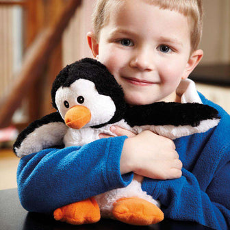 Little boy hugging Soft Warm Weighted Penguin Plush Warmies