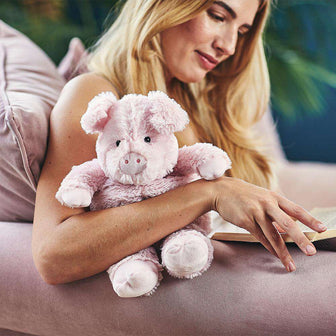 Woman hugging Cute Weighted Lavender Scented Pig Stuffed Animal Heating Pad Warmies