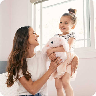 Mother and daughter holding Cute Weighted Lavender Scented Pink Bunny Stuffed Animal Heating Pad Warmies